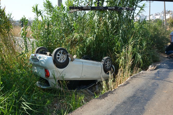 Kanala devrilen otomobilden yara almadan kurtuldular