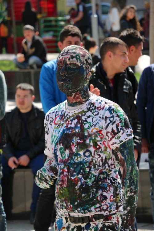 Canlı tuval olup vatandaşlara kendini boyattı